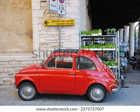 car parket near market stall and traffic sign