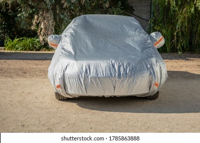 The car is in the parking with auto cover from the sun. Protection from heating the car.