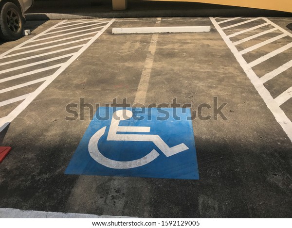 car\
parking for disable people sign on concrete\
road