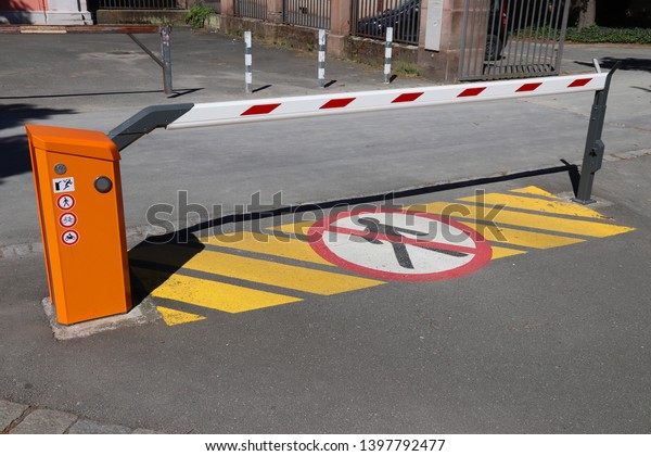 Car parking entrance automatic barrier. Generic\
red white gate barrier.