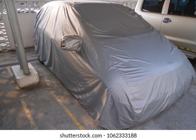 Car Is Parking In Garage Covered With Car Cover.To Protect The Sunlight And Dust.