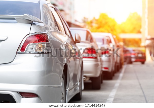 Car parking in line and car running background
with sunrise effect.