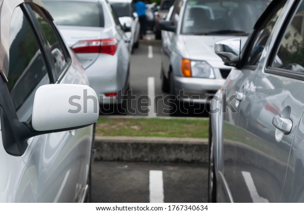 Car parking in parking lot. cars parked at\
outdoor parking lot close up, automobile transportation dealer\
business, selective focus\
