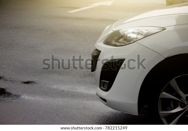 Car in\
parking with on floor have water of\
rain.