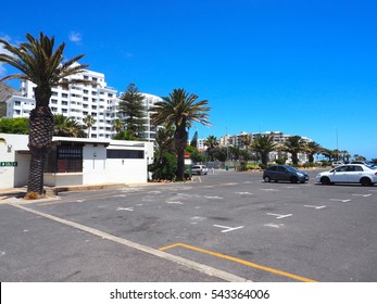 Car parking on street near the sea and hotel with blue sky background in Queen Beach, Cape Town, South Africa