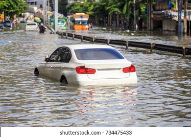 Car parking on the street and show level of water flooding in Bangkok, Thailand. - Shutterstock ID 734475433