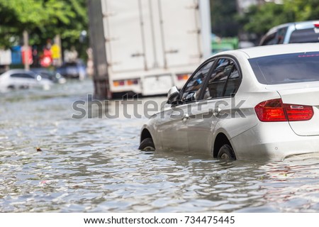 Car parking on the street and show level of water flooding in Bangkok, Thailand