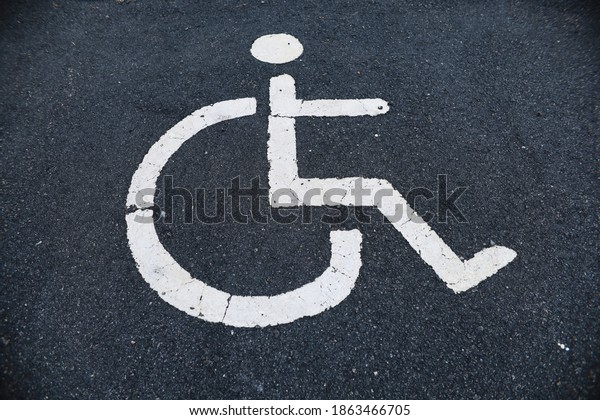car\
parking road sign for disabled outdoors with a\
cone