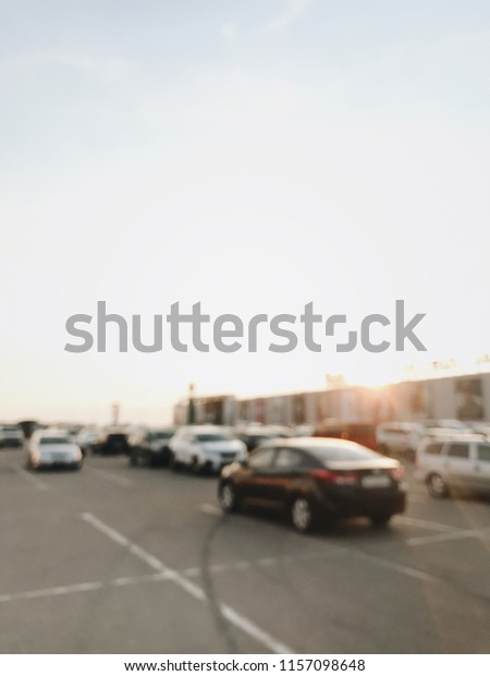car parking at a shopping center, supermarket.\
cars in the parking lot. Abstract blurred car in parking\
background. illustration to article of Parking lot. blurred photo.\
vintage photo processing