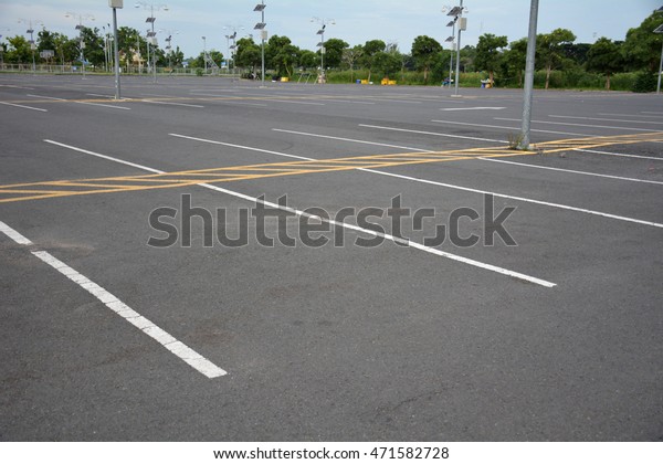 car parking\
spot on the street with a white\
line.