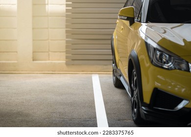 Car parking lot with white lines and blurred yellow car . Selective focus - Shutterstock ID 2283375765