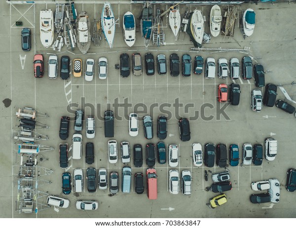 Car\
parking at the yacht club, boats and cars from\
above