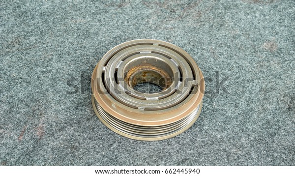 Car part and air conditioner system concept -\
Closeup old clutch pulley of car air conditioner compressor system\
and copy space