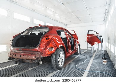 a car and its parts after painting in paint shop, full shot, repair after an accident. High quality photo - Powered by Shutterstock