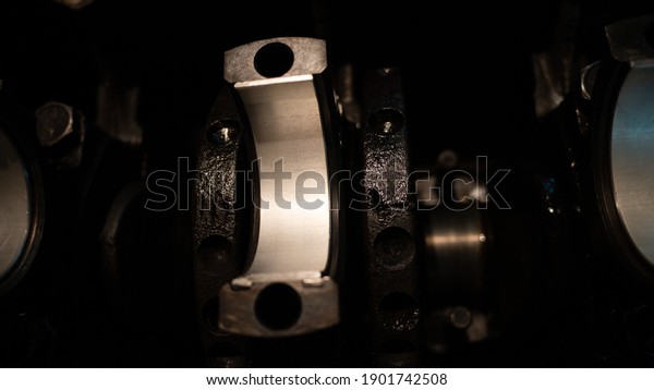 The car parts lie on the internal combustion\
engine. Close-up of connecting rods on the crankshaft. Car spare\
parts. Car engine motor\
repair