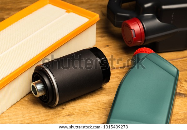 car parts, Maintenance,
machine oil, oil filter, air filter isolated on wooden background,
top view