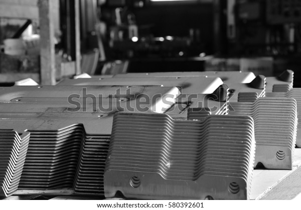 Car parts Produced by Accurate\
Sheet Metal Stamping Tool Die. Black-and-white\
photo.