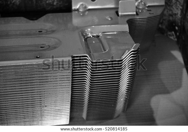 Car parts Produced by Sheet Metal Stamping Tool\
Die. Black-and-white photo.