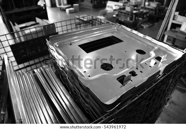 Car parts Produced by Sheet Metal Stamping Tool\
Die. Black-and-white photo.
