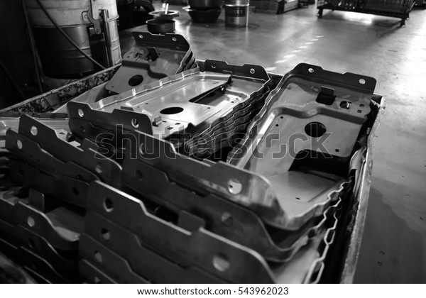 Car parts Produced by Sheet Metal Stamping Tool
Die. Black-and-white photo.