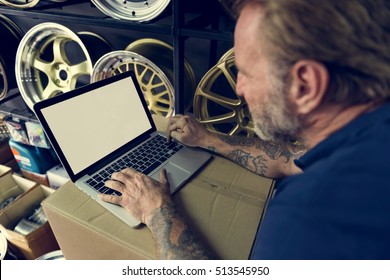 Car Parts Shop Owner Warehouse Checking Laptop Concept