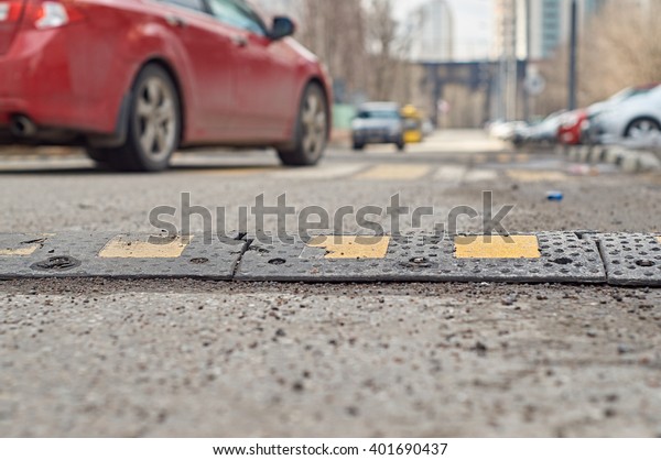     Car passing through the speed bump on the\
road                          \
