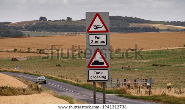 Car passing warning sign for tanks and\
helicopters on road crossing Sailsbury\
Plain