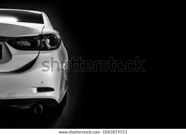 car in patches of\
light on black background