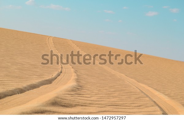 A car path\
made in the middle of the siwa\
desert