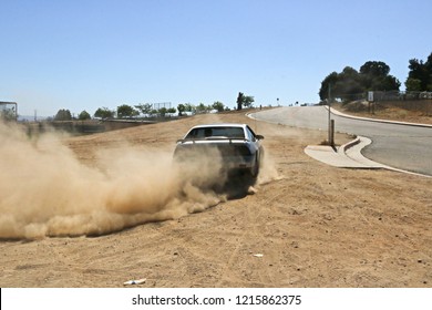 Car Peeling Out Leaving Dust Behind It