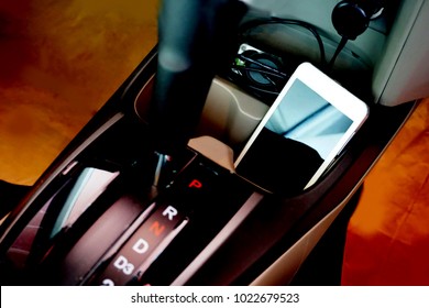 Car Phone Charger - Phone On The Dashboard In The Car - Blurred Photographic Effects