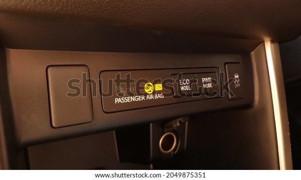 Car phone charging port and passenger airbag\
sign in a car dashboard