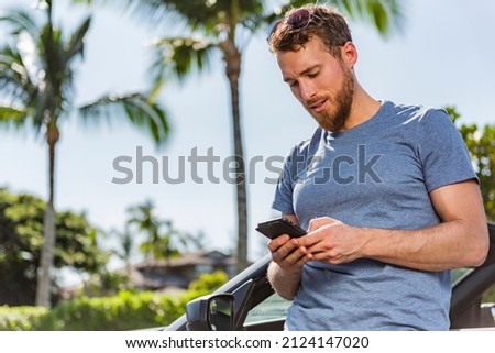 Car phone man driver using smartphone app for carsharing or travel vacation rental on new sports convertible. Summer holiday driving accident problem road trip assistance.