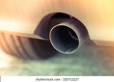 Car Pipe Exhaust Muffler Rejecting Carbon Dioxide. Slide Leak Vintage Style