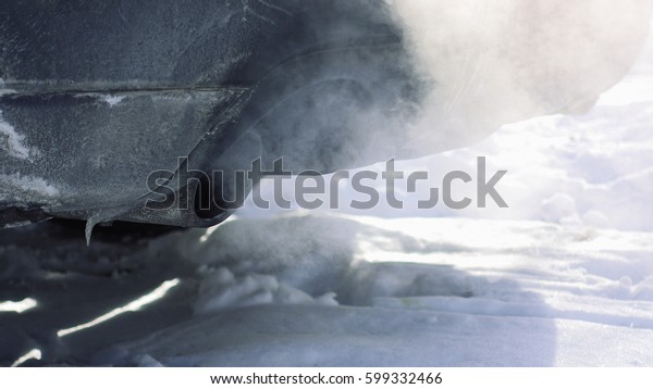 Car pipe puffs out exhaust gas clouds.\
Smoke clouds coming out of automobile tailpipe. Air and environment\
pollution by vehicle closeup\
shot.