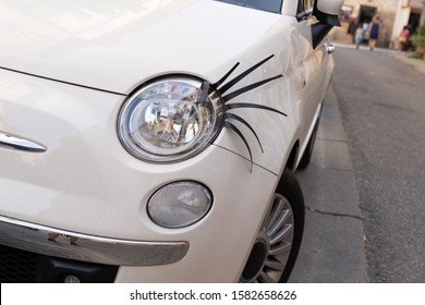 car with plastic long eyelashes on the headlight