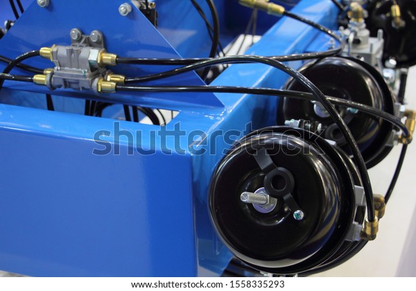 Car pneumatic brake system, air accumulators\
with pipes on truck frame close\
up