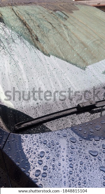 Car polish anti-rain for windows.  Drops on the\
car window.