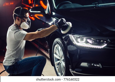 Car polish wax. worker hands holding a polisher and polish car