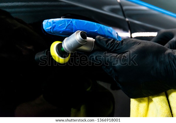 Car
polish wax worker hands applying protective tape before polishing.
Buffing and polishing car. Car detailing. Man holds a polisher in
the hand and polishes the car. Tools for
polishing