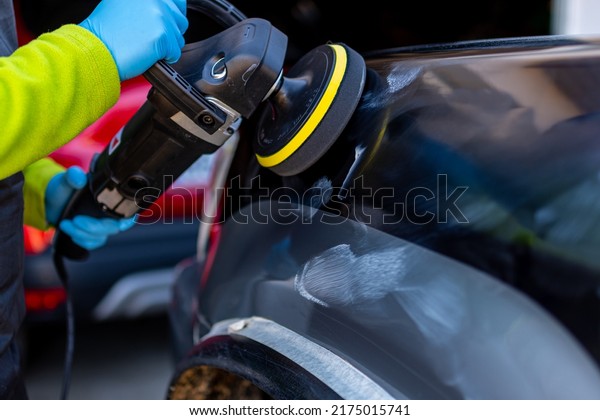car polishing with polishing machine, badly scratched\
black car