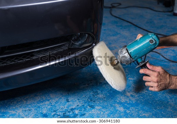 Car polishing\
series : A man waxing blue\
car