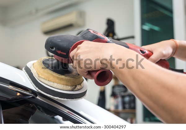 Car polishing\
series : Worker waxing white\
car