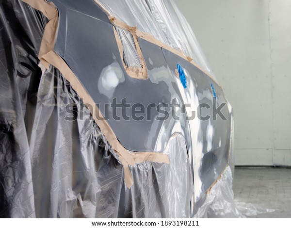 car prepared for\
painting in a spray booth.