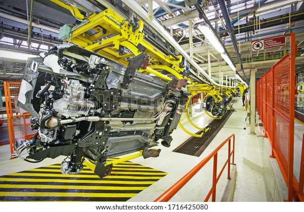 Car production line with\
unfinished cars in a row at Fca factory.  Turin, Italy - May\
2012