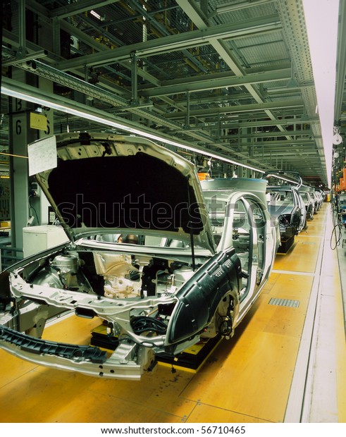 car\
production line with unfinished cars in a\
row