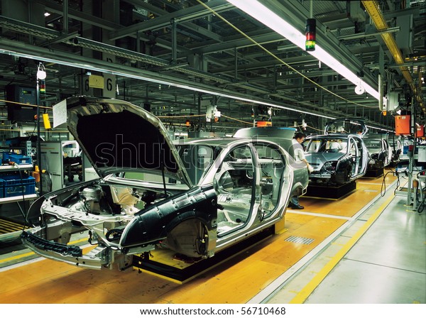 car\
production line with unfinished cars in a\
row
