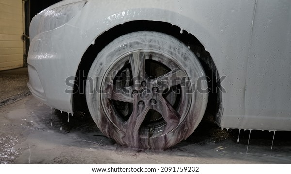 A car in\
a professional car wash - auto\
detailing