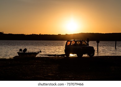 Car Pulling Boat On The Lake