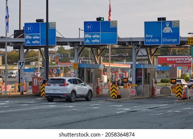 Car pulling up at the Toll Booth on McDonald Bridge over Halifax Harbour. Darmouth, Canada. October, 11, 2021
